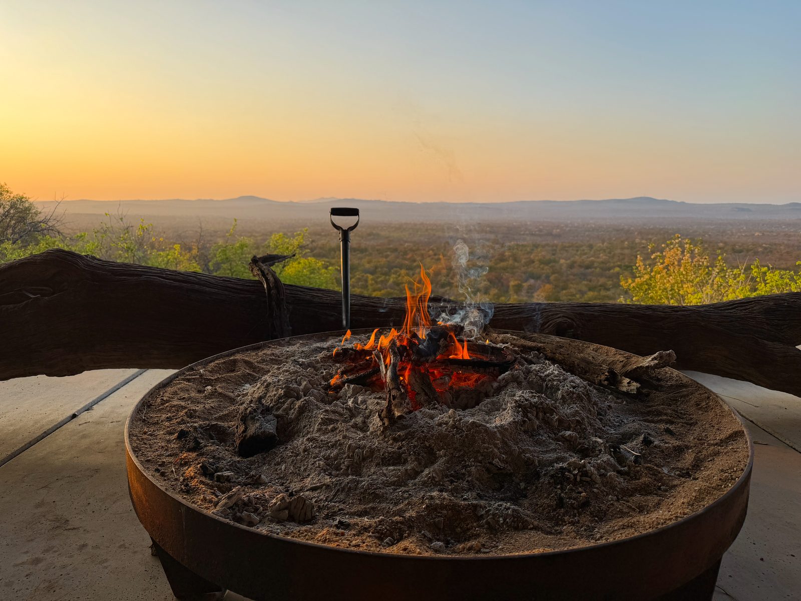 Campfire at dusk with a view over the bushveld, Kruger