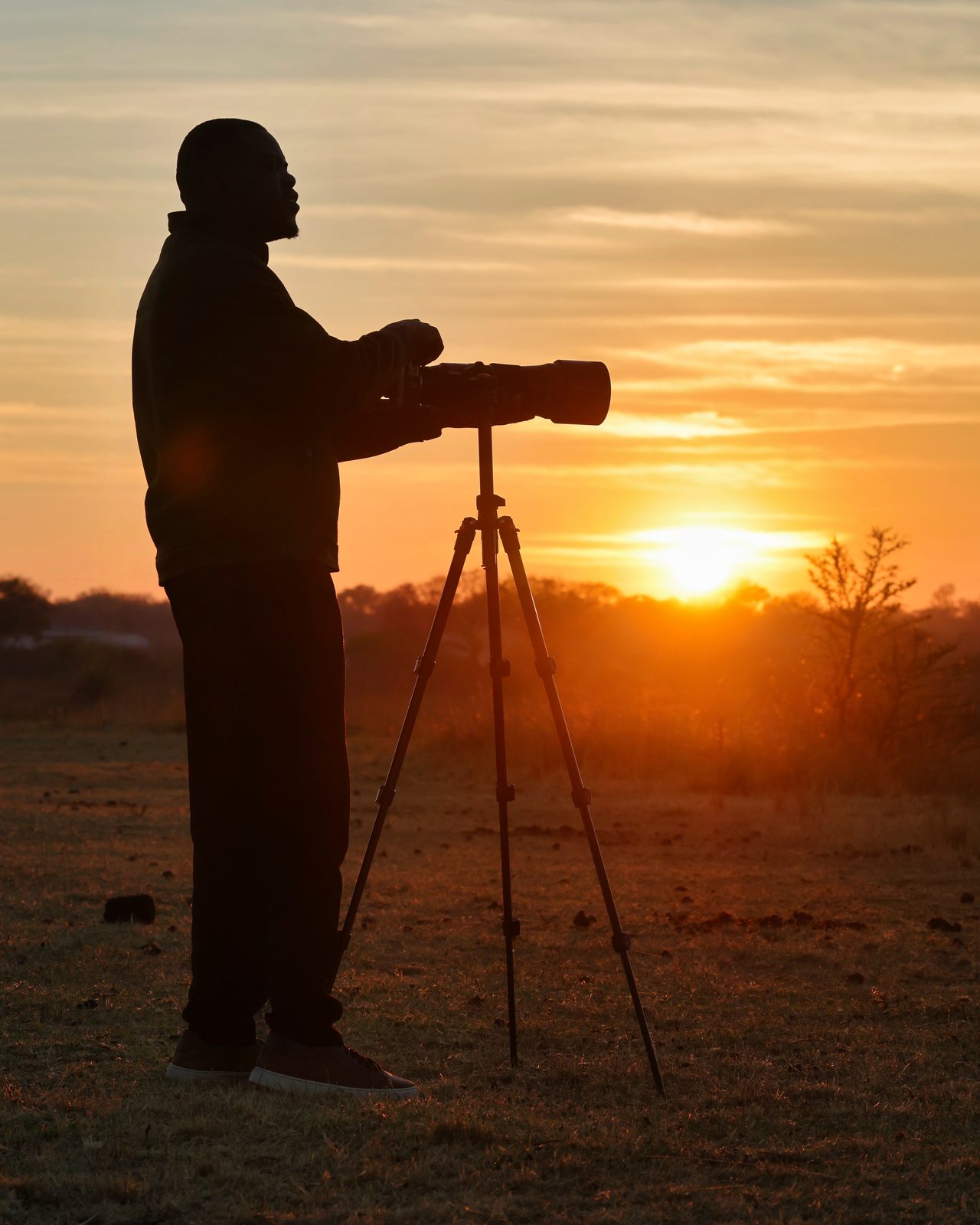 Photographer, silhouetted at sundown, Zimbabwe